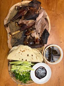 a plate of food with meat and vegetables and dips at Rancho Don Sina in Caacupé