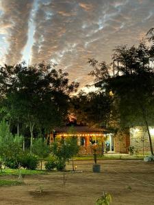 a house with lights on the front of it at Rancho Don Sina in Caacupé
