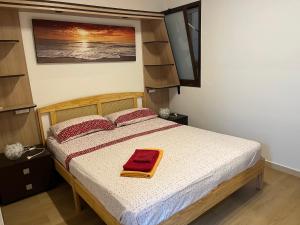 a bedroom with a bed with a red towel on it at Genova La casa di Saretta in Marina di Ragusa