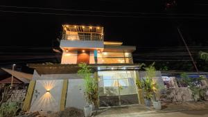 a small house with a balcony on top of it at La Casa Princesa Inn in Puerto Princesa City