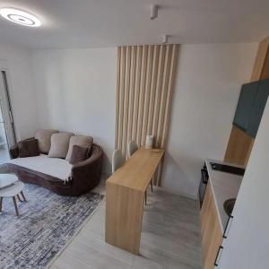 a living room with a couch and a table at Lux apartmani boka in Tivat