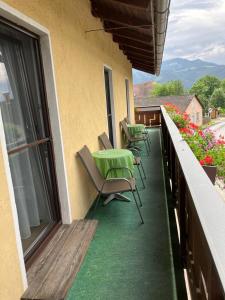 a balcony with chairs and a table on a building at Gasthaus Mossauer in Feistritz bei Knittelfeld +4 photos