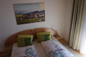 a bedroom with two beds and a painting on the wall at Gasthaus Mossauer in Feistritz bei Knittelfeld