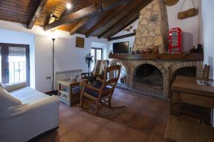 a living room with a fireplace and a couch at Casa Ribera de Cazorla in Cazorla