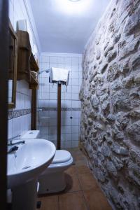 a bathroom with a white toilet and a sink at Casa Ribera de Cazorla in Cazorla