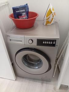 a washing machine with a bowl on top of it at Carregado Groundfloor in Carregado