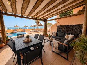 a patio with a table and chairs and a couch at Terrazas 532 in San Miguel de Abona
