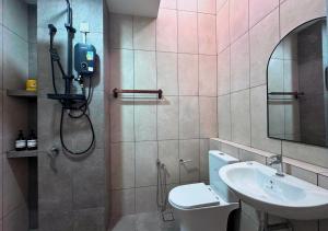 a bathroom with a shower and a toilet and a sink at Gamuda Cove 4BR SplashMania in Banting +25 photos