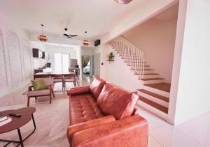 a living room with a couch and a staircase at Gamuda Cove 4BR SplashMania in Banting