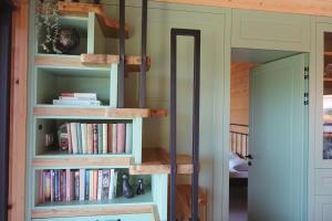 a room with a book shelf with books at BOHO Forest Retreat in Novo Mesto