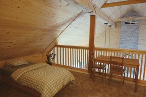 a bedroom with a bed and a desk in a cabin at BOHO Forest Retreat in Novo Mesto