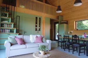 a living room with a couch and a table at BOHO Forest Retreat in Novo Mesto