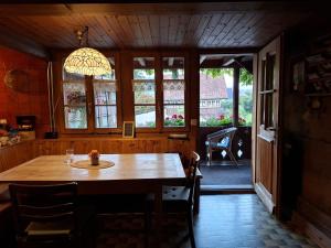 a dining room with a table and a window at bed and breakfast Liechti in Wattenwil