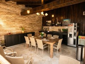 a kitchen with a table and chairs and a refrigerator at Villa DeaDorata in Oradea