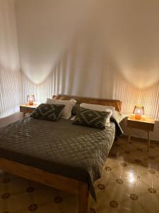 a bedroom with a bed with two lamps on two tables at A casa di Rita in Toro +35 photos
