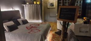 a bedroom with a bed with red decorations on it at Lyon Campagne in Rontalon