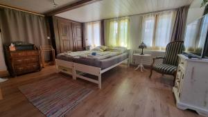 a bedroom with a bed and a table and a chair at bed and breakfast Liechti in Wattenwil