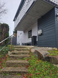 a house with stairs leading up to the front of it at Ferienwohnung beim Belchen in Wieden