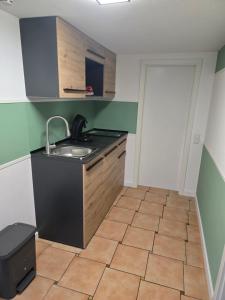 a kitchen with a sink and a tiled floor at Ferienwohnung beim Belchen in Wieden +3 photos