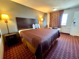 a hotel room with a large bed and a window at Royal Regency Inn in Rock Hill +20 photos