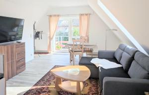 a living room with a couch and a table at Ferienwohnung Waldblick in Fuhlendorf