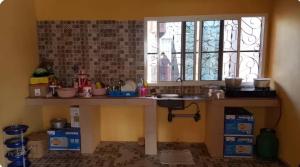 a kitchen with a sink and a window at Studio Cosy Mde Comores 