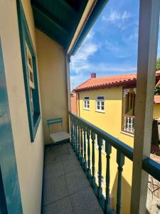 a balcony of a building with a bench on it at Charming Casa Azul - Stay in Historic Chaves in Chaves