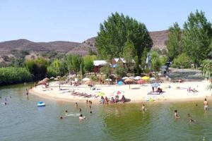 a group of people on a beach in the water at Pool&River Villa in Alcoutim