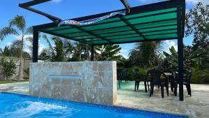 a patio with a table and chairs next to a pool at The Resident 