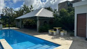 a swimming pool with a gazebo and a picnic table at The Resident 