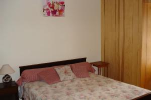 a bedroom with a bed with two pillows on it at Chez ellen in La Tour-dʼAuvergne