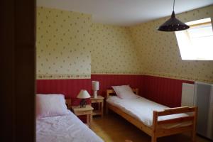 a bedroom with two beds and a window at Chez ellen in La Tour-dʼAuvergne