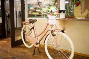 a pink bike parked in front of a store at Almonds & Corals Boutique Hotel in Puerto Viejo