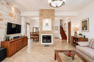 a living room with a couch and a fireplace at Casa Adam and spa in Zakynthos