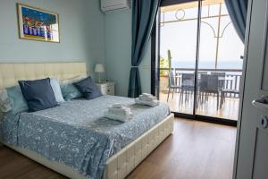 a bedroom with a bed and a view of the ocean at Little Paradise in Taormina +125 photos