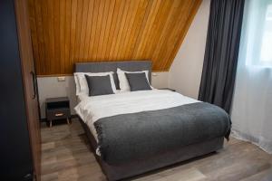 a bedroom with a large bed in a room at AVA Chalet with Jacuzzi in Sinaia +72 photos