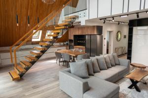 a living room with a couch and a table at AVA Chalet with Jacuzzi in Sinaia