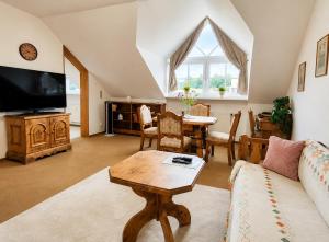 a living room with a couch and a table at Kurpark Suite in Bad Rodach