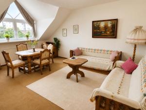 a living room with a couch and a table at Kurpark Suite in Bad Rodach