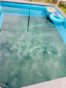 a swimming pool with two frisbees in the water at Gariks house in Lichkʼ +6 photos
