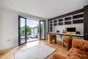 a living room with a desk and a television at Mincarlo House in St Austell