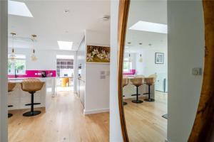 a kitchen and a living room with a mirror at Mincarlo House in St Austell