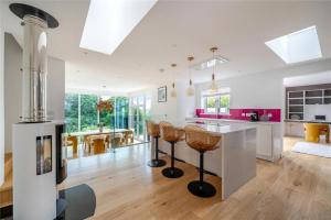 a kitchen with a counter and chairs in a room at Mincarlo House in St Austell
