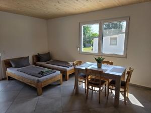 a living room with a table and a dining room at Little Break 2, Nähe Legoland in Röfingen