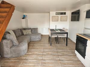a living room with a couch and a table at Gîte MARS in Torcenay +12 photos