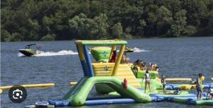 a water slide in the water with people on it at Gîte MARS in Torcenay