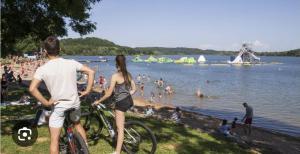 a man and a woman on bikes at a beach at Gîte MARS in Torcenay