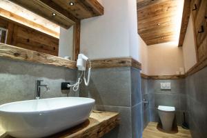 a bathroom with a sink and a toilet at Alla Frasca Verde in Lauco +31 photos