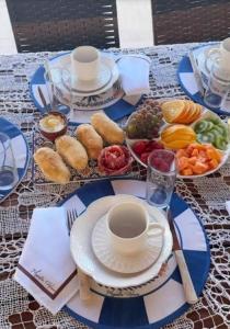 a table with plates of food and a cup of coffee at Joy Apartamento completo in Salvador
