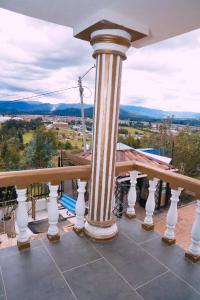 a view from the balcony of a house with a column at Apartamento THEMIS Tocancipa in Bemposta
